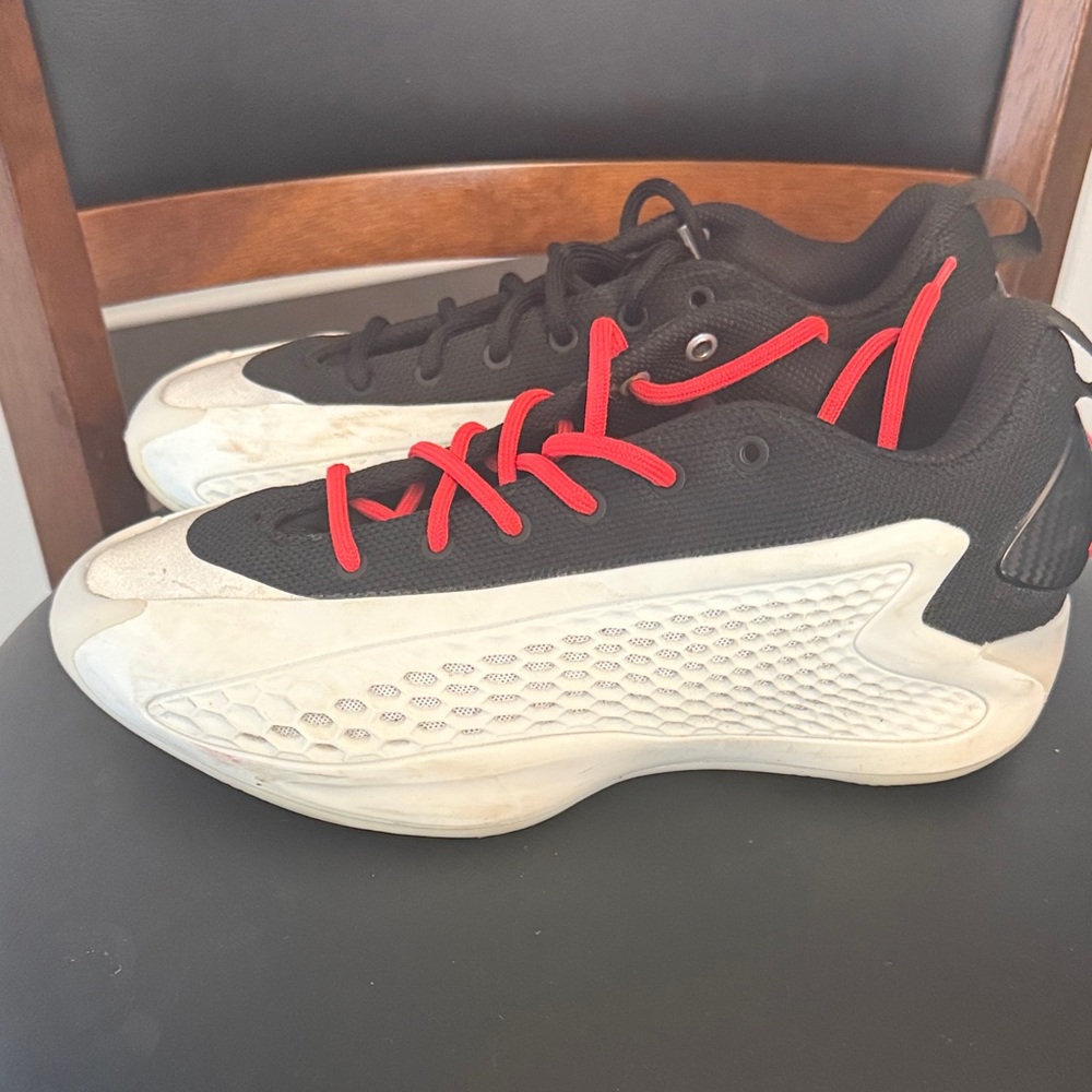 AE1s
adidas Black and White Sneakers with Red Accents